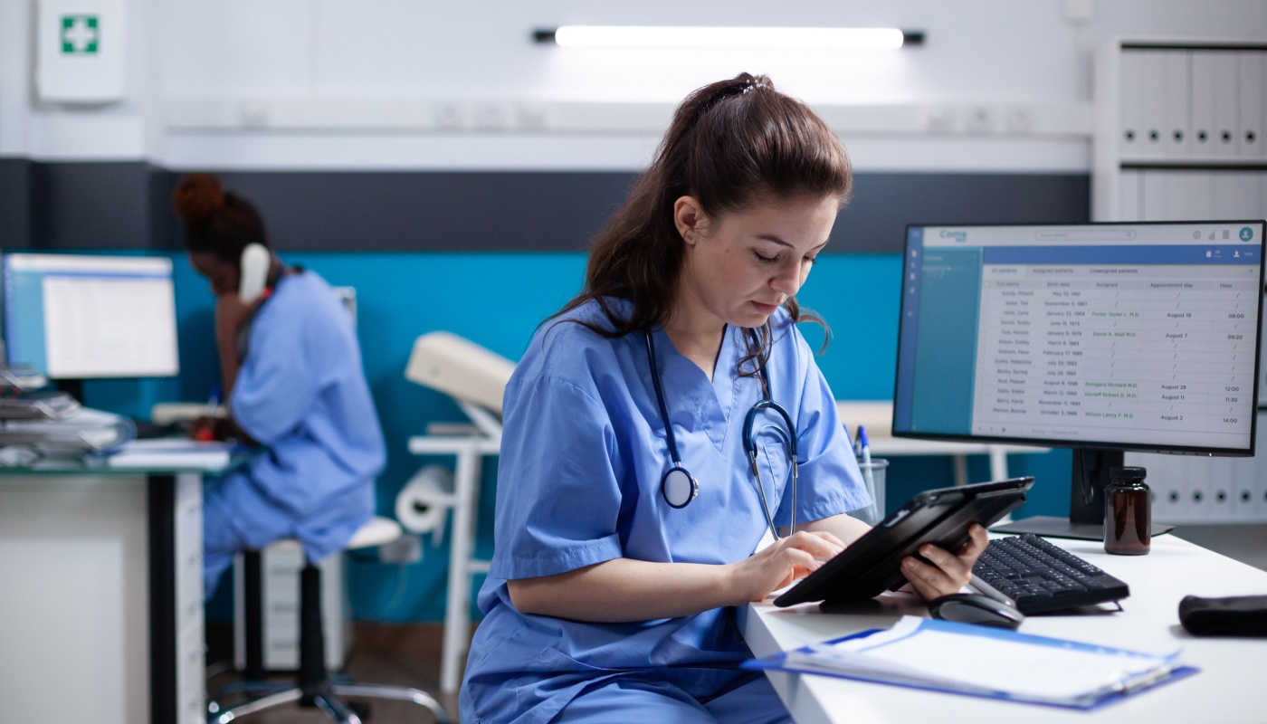 Healthcare professional working on tablet; patient safety concept