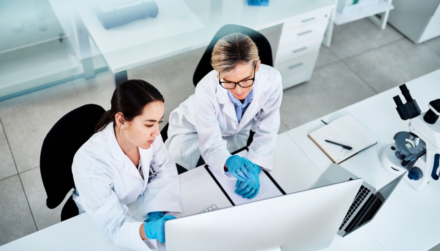 Two scientists working together in lab; data integrity concept