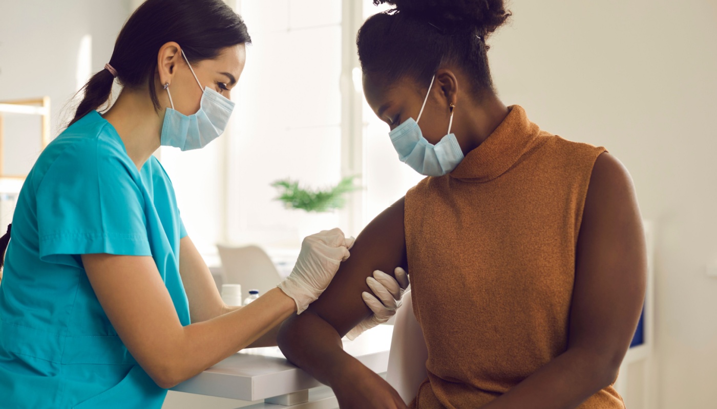 Healthcare provider giving patient an injection; diversity and inclusion in clinical trials concept